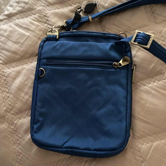 Traveling Blue cross body anti theft travel bag. - Picture 2 of 4